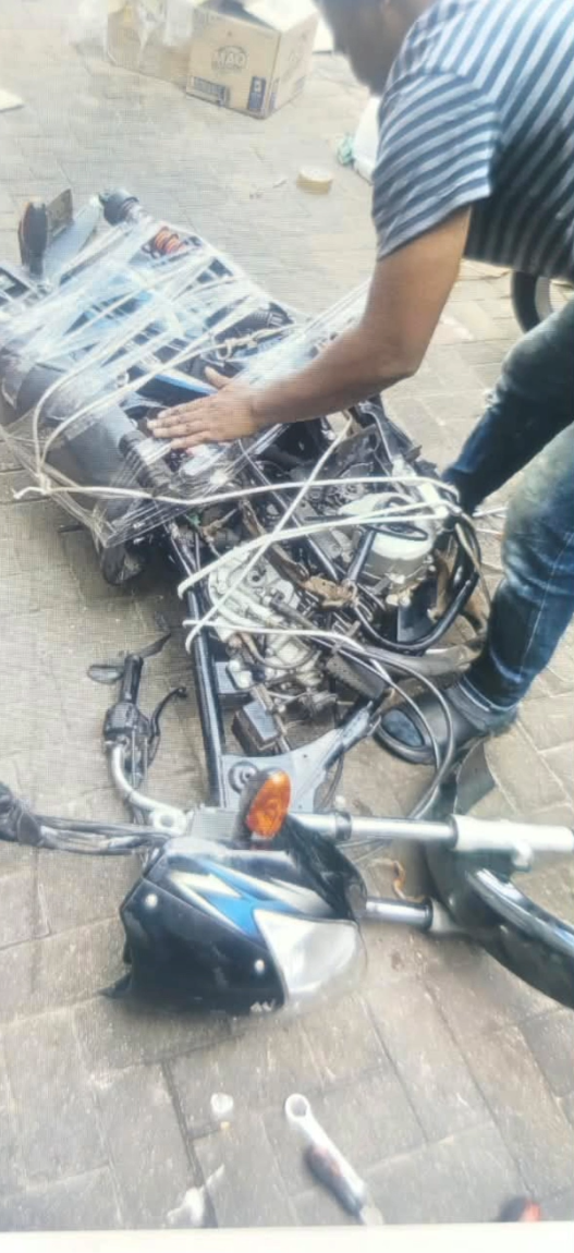 A stripped motorcycle frame with its front fairing and handlebars removed, wrapped in plastic
